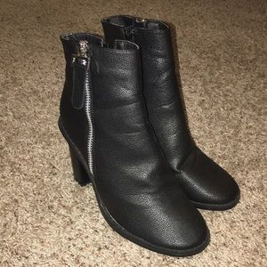 Black booties with silver zip accent